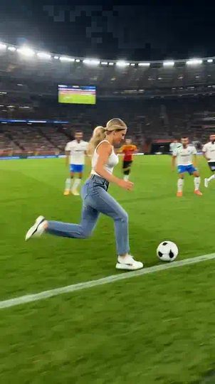 AI football player video: a fan jumps the barrier at a night match and dribbles the ball among the players